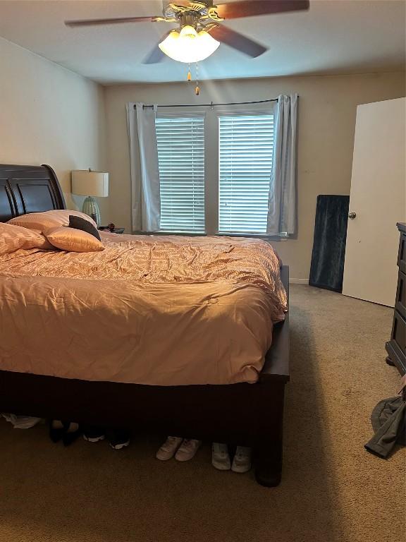 carpeted bedroom with ceiling fan