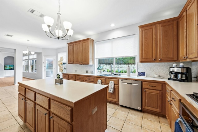 kitchen with pendant lighting, a healthy amount of sunlight, stainless steel appliances, and a chandelier