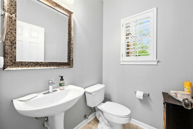 bathroom with tile patterned flooring, toilet, and sink