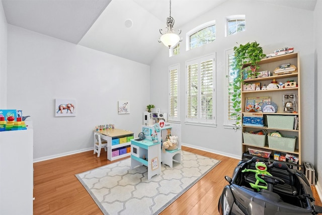 game room featuring hardwood / wood-style floors and lofted ceiling