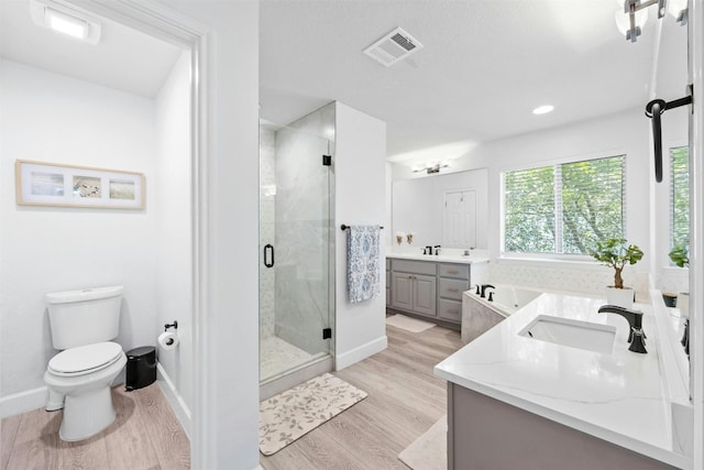 full bathroom featuring vanity, hardwood / wood-style flooring, toilet, and independent shower and bath