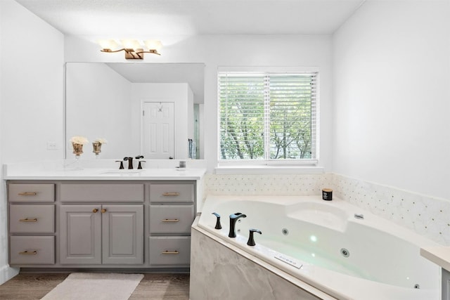 bathroom featuring vanity, hardwood / wood-style flooring, and a bathtub