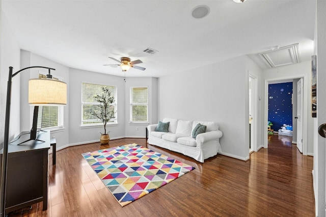 living room featuring dark hardwood / wood-style flooring and ceiling fan