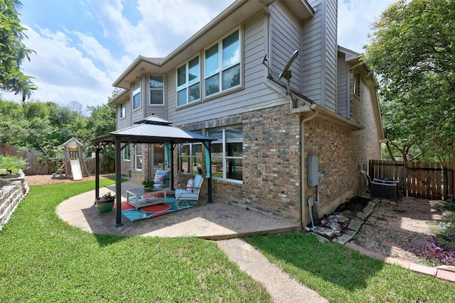 back of house featuring a gazebo, central AC unit, a yard, and a patio