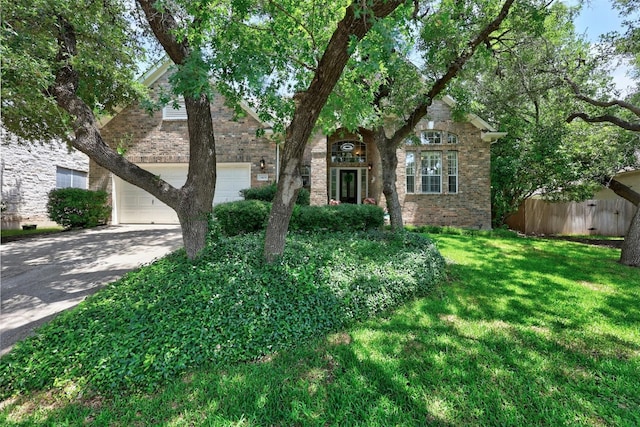 obstructed view of property featuring a garage and a front lawn