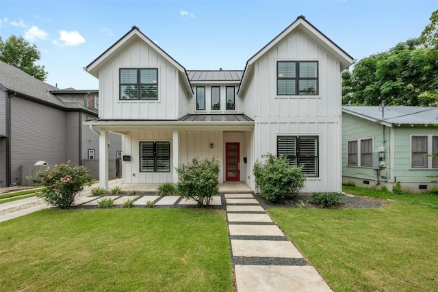 modern inspired farmhouse featuring covered porch and a front yard