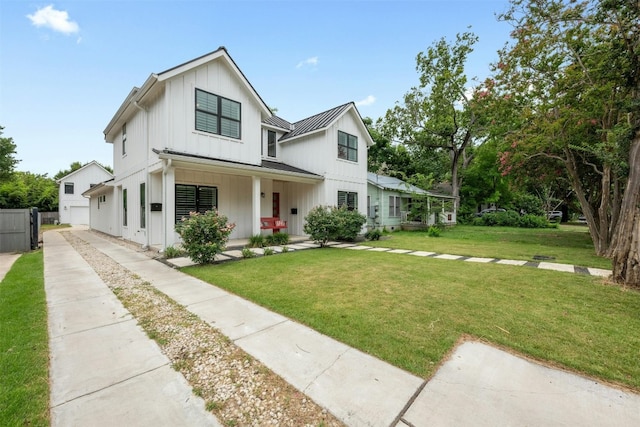 modern farmhouse style home with a porch and a front lawn