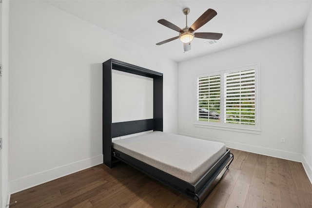 bedroom with ceiling fan and dark hardwood / wood-style flooring