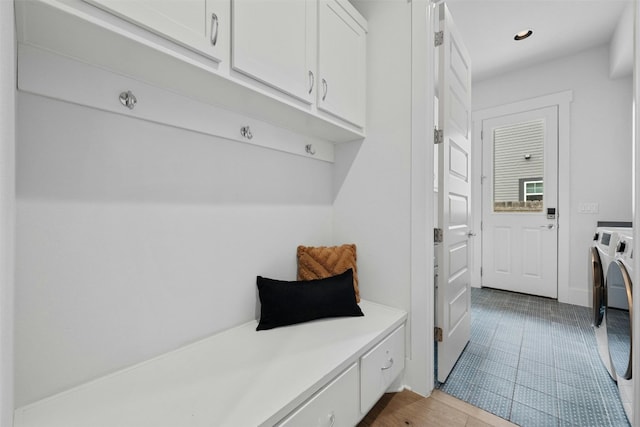 mudroom featuring light tile patterned floors and independent washer and dryer