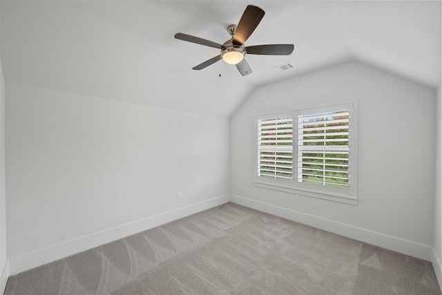 additional living space with ceiling fan, light carpet, and lofted ceiling