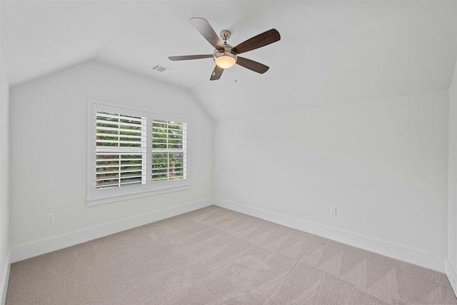 interior space with ceiling fan, lofted ceiling, and light carpet