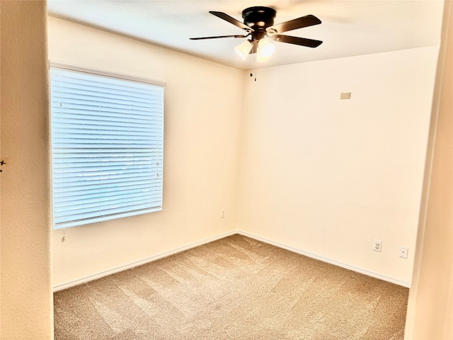 carpeted spare room featuring ceiling fan