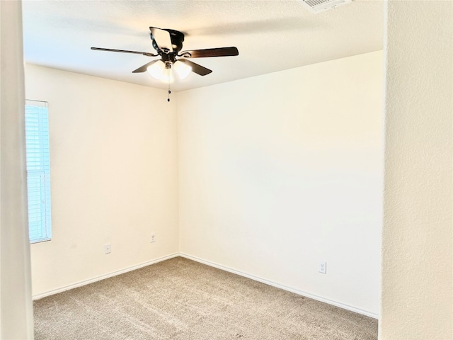 carpeted spare room with ceiling fan