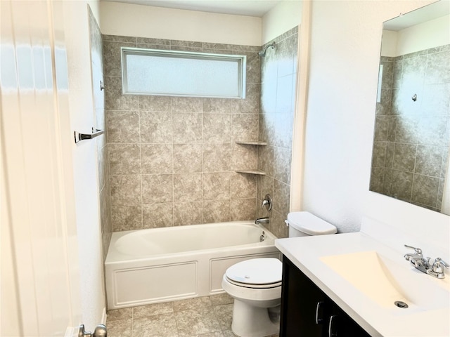 full bathroom featuring tile floors, tiled shower / bath combo, vanity, and toilet