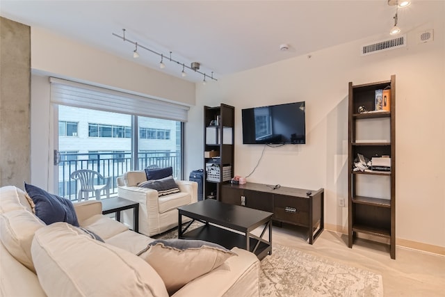 living room featuring rail lighting, visible vents, and baseboards