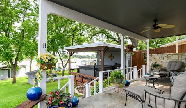 view of patio / terrace with a hot tub and ceiling fan