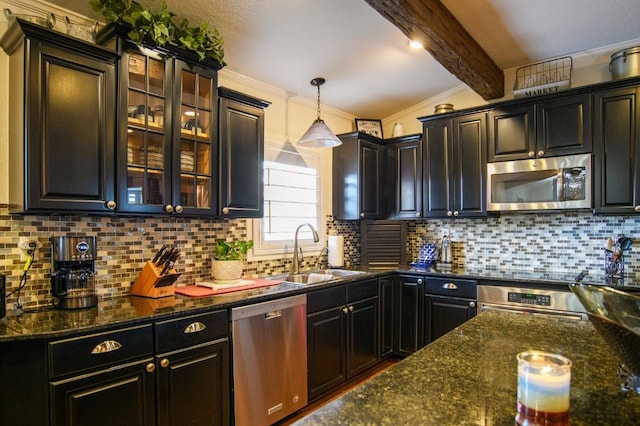 kitchen with crown molding, sink, hanging light fixtures, decorative backsplash, and stainless steel appliances