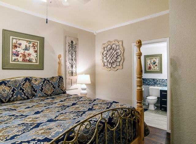 bedroom featuring dark hardwood / wood-style floors, crown molding, and ensuite bath