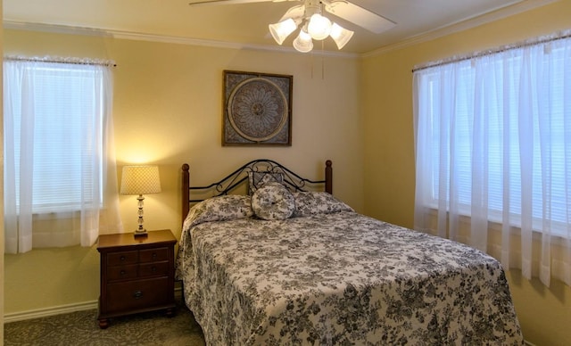 bedroom with ceiling fan, carpet floors, and ornamental molding