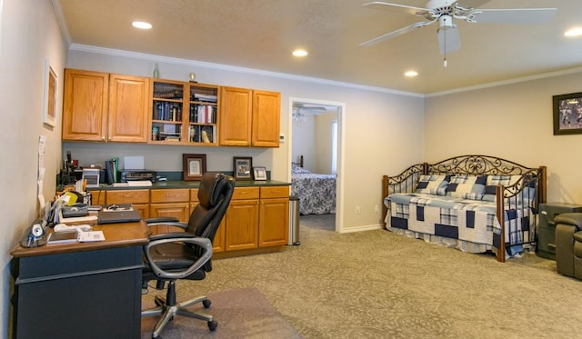 interior space featuring built in desk, ceiling fan, and ornamental molding