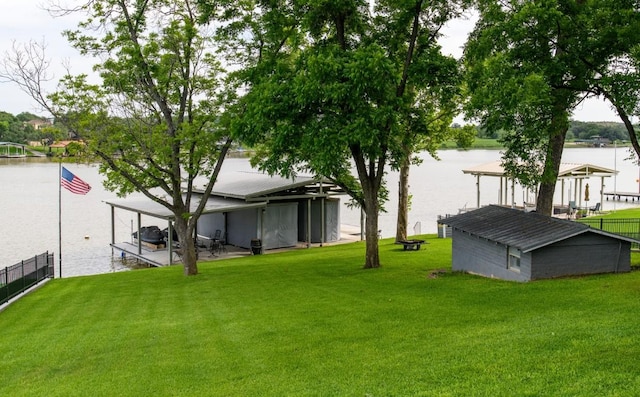 view of yard featuring a boat dock and a water view