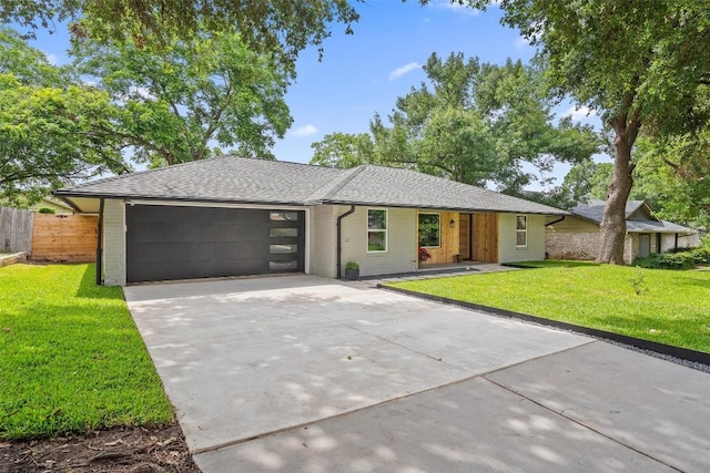 single story home featuring a front yard and a garage