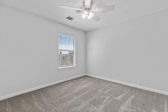 spare room featuring carpet and ceiling fan