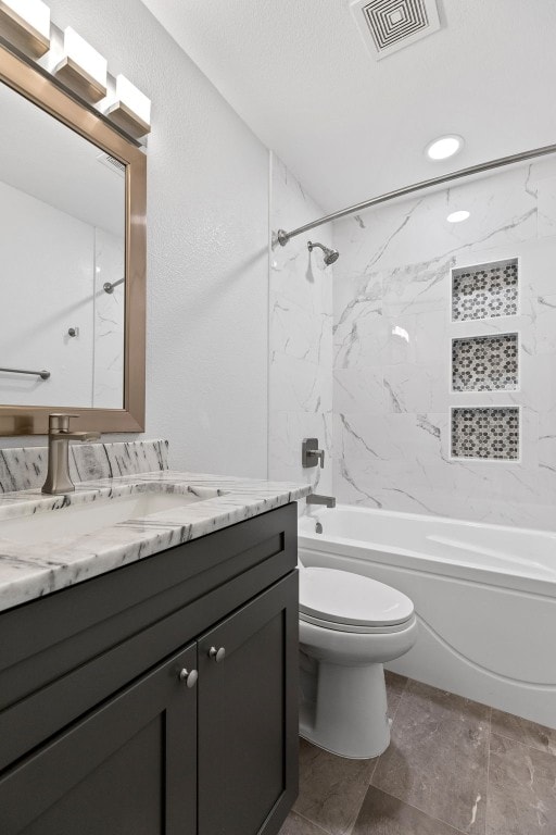 full bathroom with vanity, toilet, and tiled shower / bath