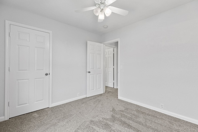 unfurnished bedroom featuring carpet floors and ceiling fan