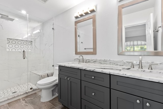 bathroom with vanity, toilet, and a shower with shower door