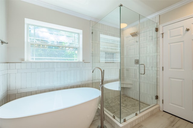 full bathroom featuring a stall shower, a freestanding bath, ornamental molding, and tile walls