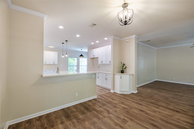 interior space featuring a chandelier, ornamental molding, and hardwood / wood-style floors