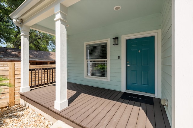 view of exterior entry featuring a porch