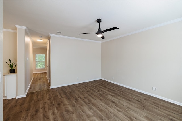 empty room featuring ceiling fan, visible vents, baseboards, dark wood finished floors, and crown molding