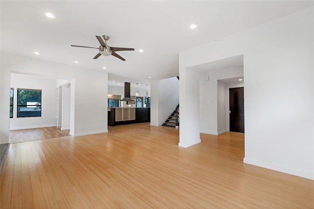 unfurnished living room with ceiling fan and light hardwood / wood-style floors