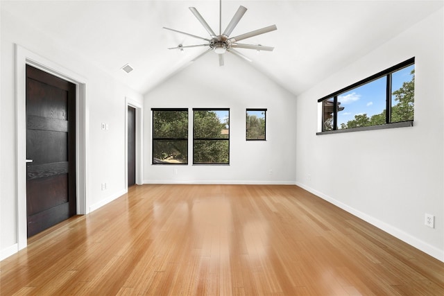 empty room featuring ceiling fan, lofted ceiling, and light hardwood / wood-style floors