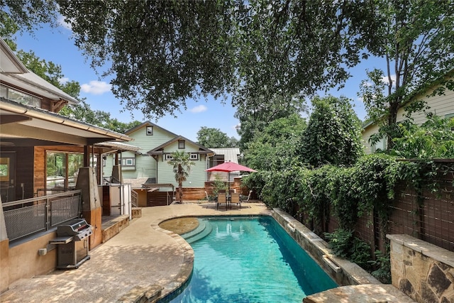 view of swimming pool with a patio