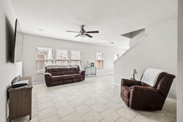 living room featuring ceiling fan and light tile patterned flooring