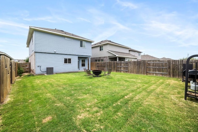 back of house featuring central AC and a lawn