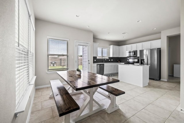 dining space with sink and light tile patterned floors