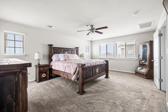 bedroom featuring multiple windows, ceiling fan, and light carpet