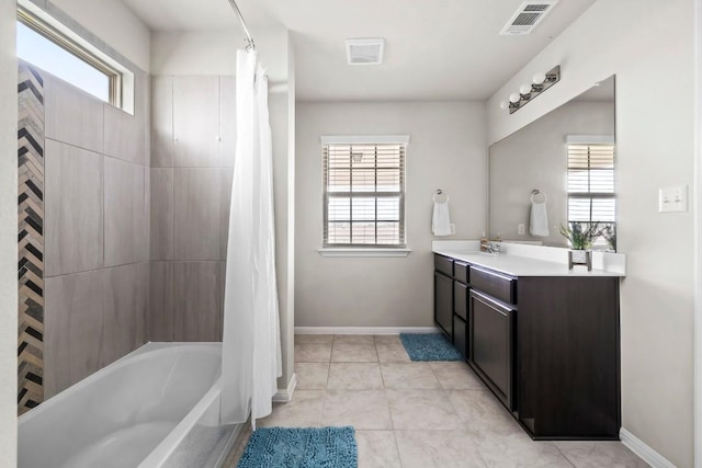 bathroom featuring vanity, shower / tub combo with curtain, and plenty of natural light