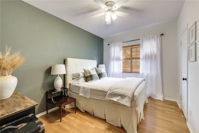 bedroom with ceiling fan and light wood-type flooring