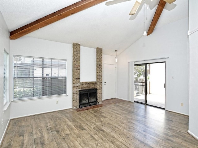 unfurnished living room with high vaulted ceiling, dark hardwood / wood-style floors, ceiling fan, a fireplace, and beamed ceiling