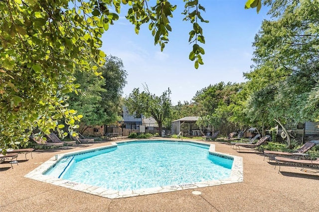 view of swimming pool featuring a patio area