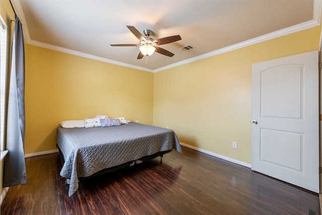 bedroom featuring dark hardwood / wood-style flooring, ceiling fan, and crown molding