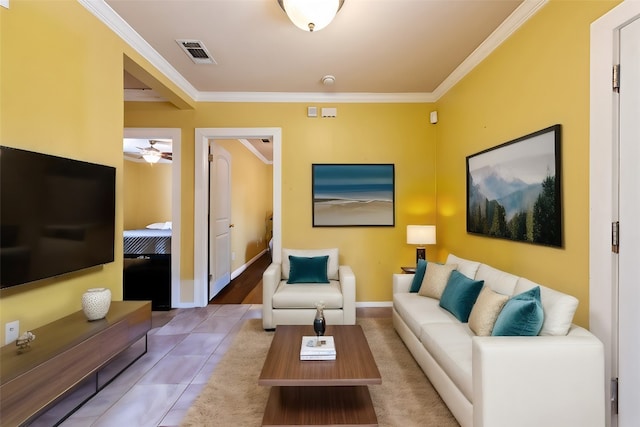 tiled living room with ornamental molding and ceiling fan