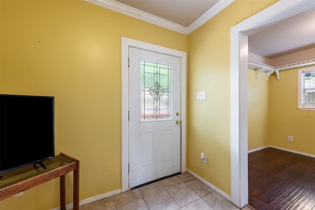 tiled entrance foyer featuring plenty of natural light and ornamental molding