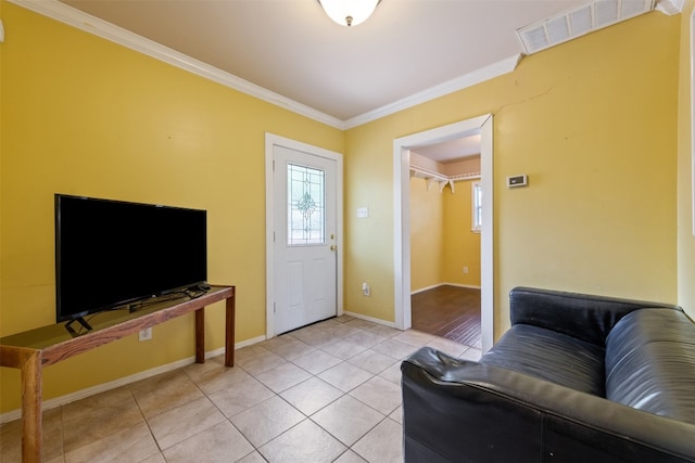 living room featuring light tile flooring and crown molding