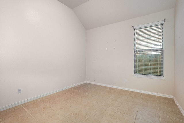 unfurnished room featuring lofted ceiling